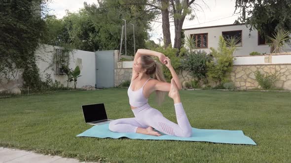 Flexible woman doing yoga in King Pigeon pose