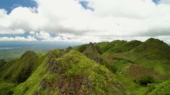 Aerial view of peak Chocolate hills and cloudy sky in Badian, Philippines.