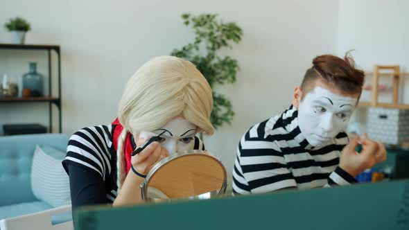 Girl and Guy Pantomimists Using Make-up and Face-paint To Create Performance Grimaces