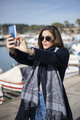 Pretty woman taking selfies in marina - PhotoDune Item for Sale