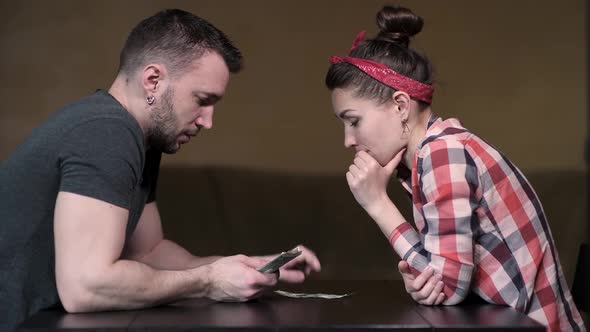 Husband and wife count the remnants of cash accumulation