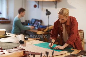 nrecognizable young man on background doing their job in craft workshop