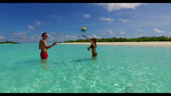 Family of two relax on relaxing tourist beach break by aqua blue ocean and white sand background of 