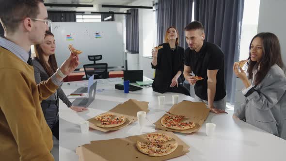 Office Party Where the Team Eats Pizza and Communicates