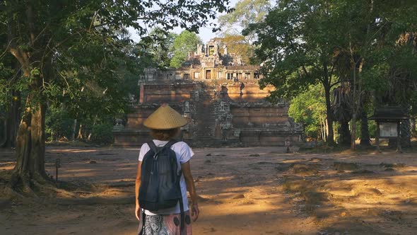 Slow motion: one tourist visiting Angkor ruins at sunrise, travel destination Cambodia