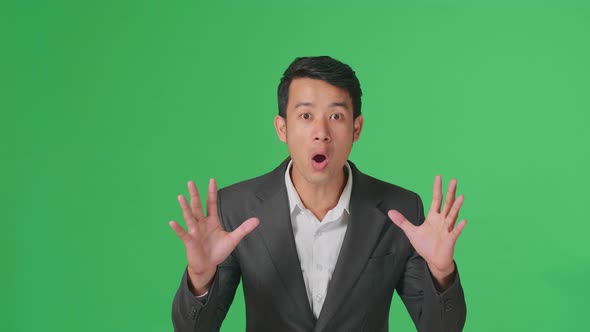 The Shocked Asian Business Man Grabbing Her Head While Saying Wow On Green Screen Background