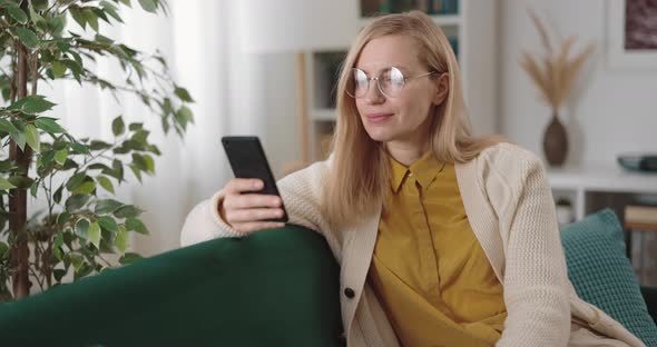 Woman with Mobile on Couch