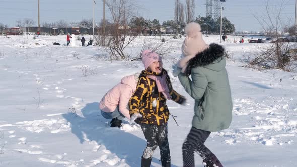 Family play with snow balls.