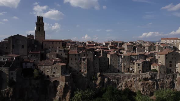 -SHOT: slider, side-DESCRIPTION: drone video over the side of Pitigliano, Italy-HOUR.WEATHER: summ