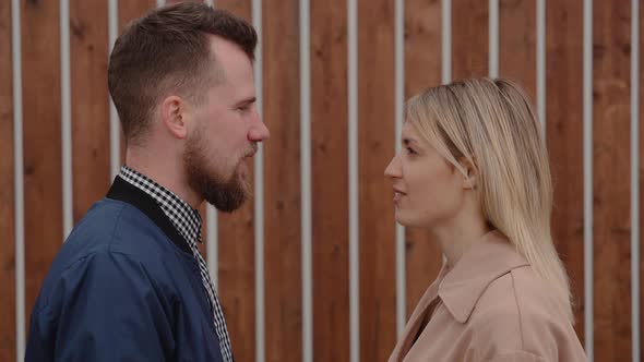 Bearded Man and Blonde Woman Are Looking To Each Other and Talking Synchrony