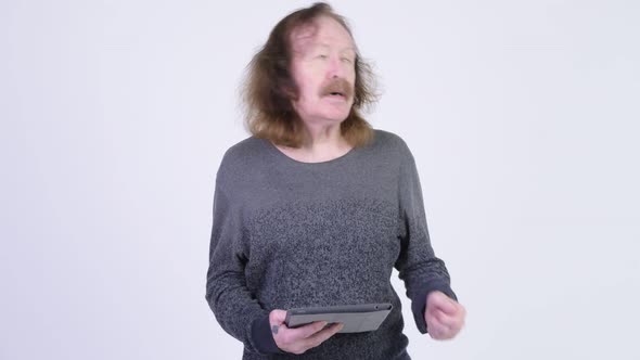 Stressed Senior Man with Mustache Using Digital Tablet and Getting Bad News