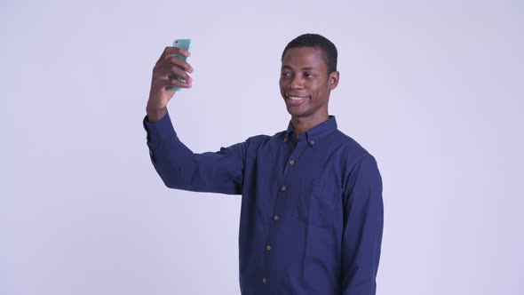 Young Happy African Businessman Taking Selfie