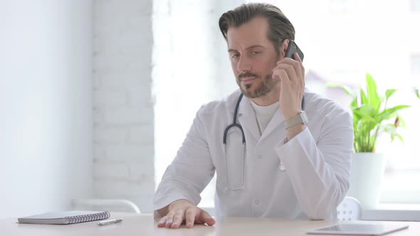 Young Doctor Talking on Phone in Clinic