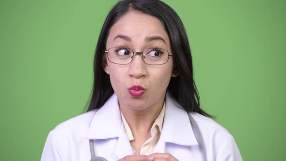 Young Beautiful Asian Woman Doctor Looking Shocked