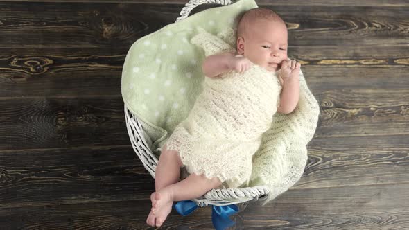 Child in Basket with Bow.