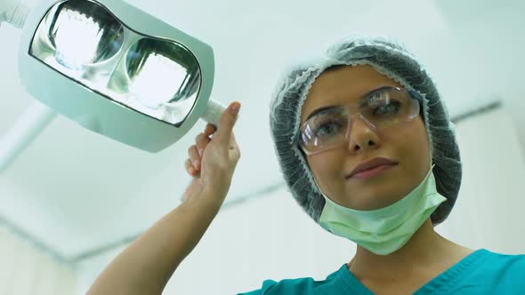 Surgeon Adjusting Lighting Before Operation, Plastic Surgery, Cosmetology