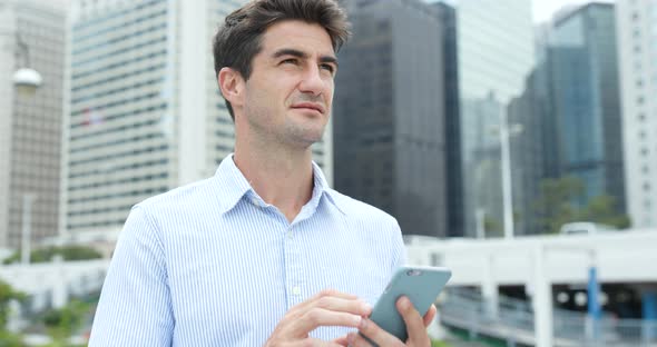 Business man use of cellphone in city