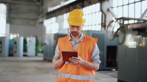 Man engineer in uniform calculating on tablet