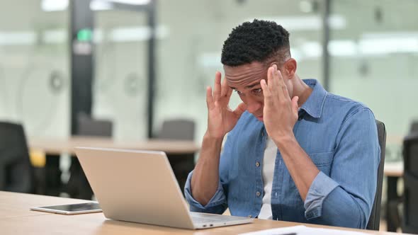 Stressed Casual African Man Having Headache in Office 