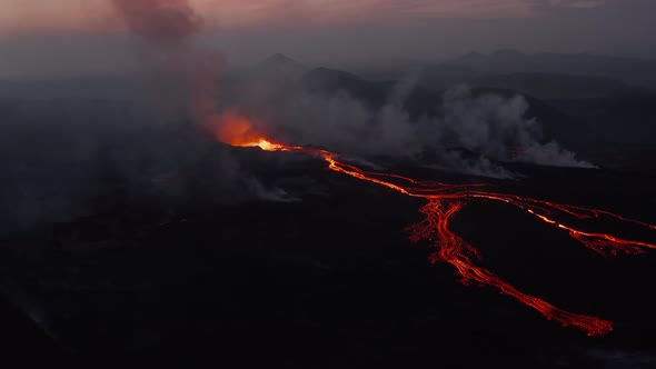 Tilt Up Footage of Active Volcano Against Pink Dawn Sky