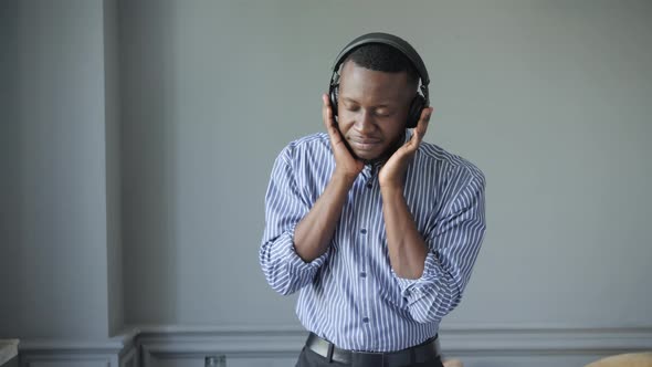 an African American with Headphones Listening to Music and Enjoying and Slowly Dancing