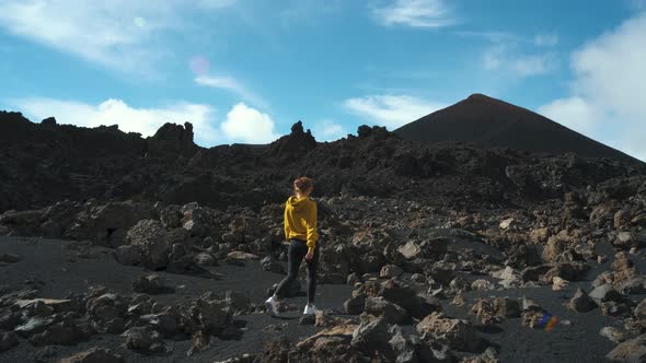 Woman Traveler Walks Through the Lava Field Around Chinyero Volcano in the Teide National Park on