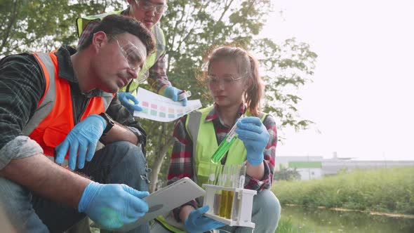 Academicians and assistants check contaminants in factory wastewater in a test tube