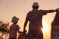 Father and son playing in the park at the sunset time. - PhotoDune Item for Sale
