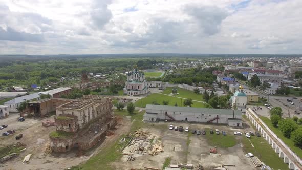 Aerial view of monastery surrounded by a brick wall alt