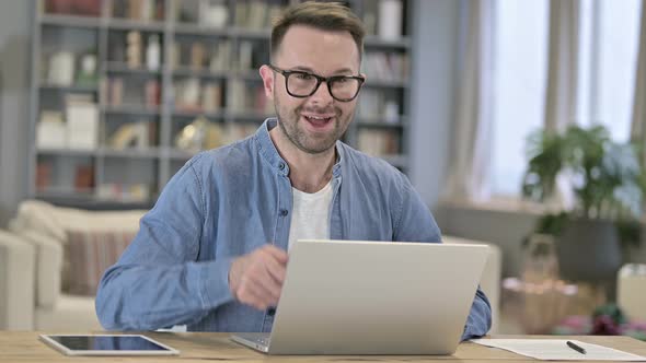 Portrait of Young Man Showing Thumbs Up in Loft Office 