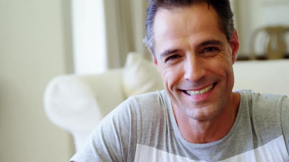 Portrait of smiling man in living room