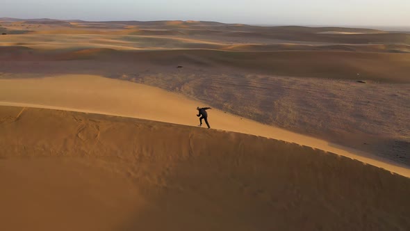 Aerial view of people walking on a sand dune crest in Namib Desert, Namibia.