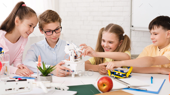 Smart school children touching diy robot at stem lesson