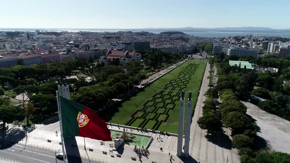 Aerial View of Portugal Flag Waving in the Wind on Eduardo VII Park Lisbon