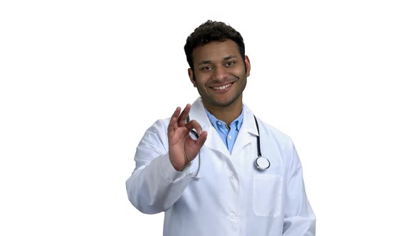 Portrait of Happy Young Doctor Showing Ok Sign
