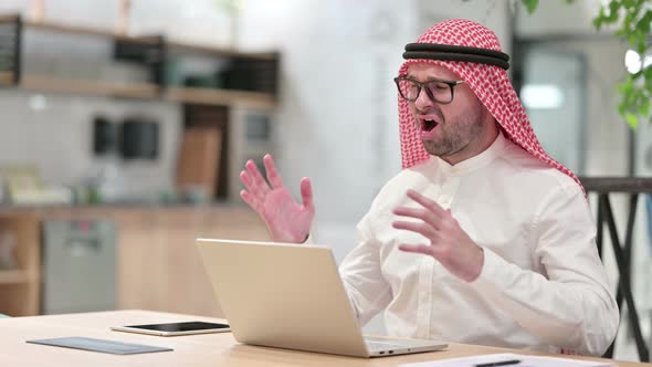 Young Arab Businessman Reacting To Failure on Laptop in Office, Loss 