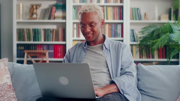 Portrait of Emotional Happy African American Young Man with Laptop in Hands