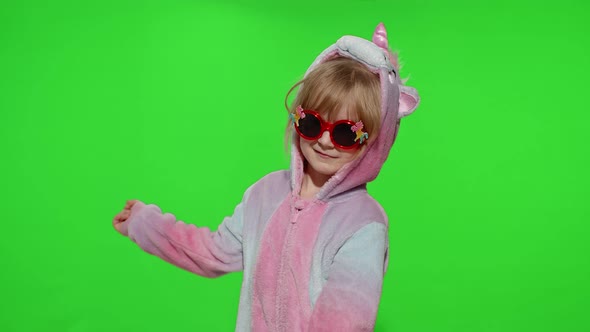 Little Child Girl Smiling Dancing Making Gun Gesture with Hands in Unicorn Pajamas on Chroma Key