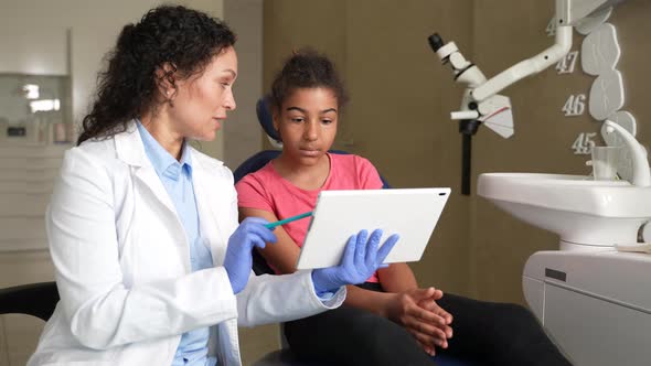 Pediatric Dentist Showing Dental Xray to Child