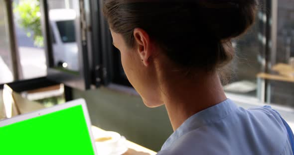 Smiling businesswoman using laptop