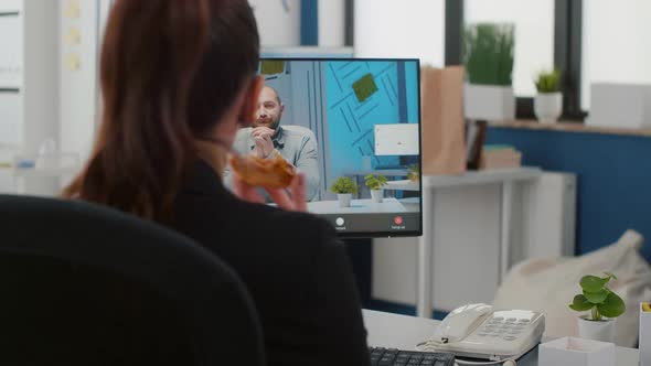 Executive Manager Eating Delivery Takeaway Pizza During Online Videocall Conference Meeting