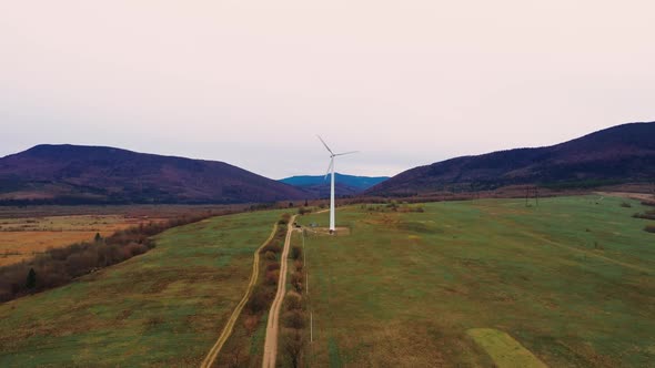 Lonely windmill in the field between Carpathian mountains of Ukraine