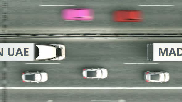 Trucks with MADE IN UAE Text Driving Along the Highway