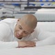 Young Man Trying Orthopedic Mattress at Furniture Store - VideoHive Item for Sale
