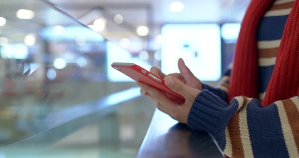 Close up of woman use of mobile phone in shopping center