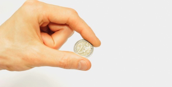 Male Hand Holding 2 Euro Coin