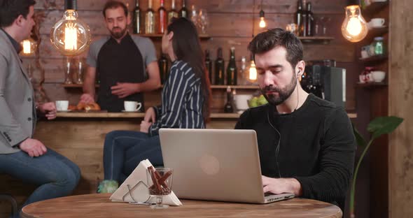 Slide Shot of a Young Male Entrepreneur Who Works Focused on His Laptop