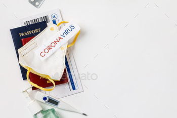 e tickets, sanitizer, thermometer and medical mask flat lay. Border control and quarantine of tourists infected with coronavirus. Flight cancellation coronavirus pandemic. Coronavirus Covid-19