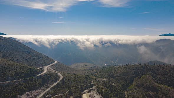 Aerial drone hyperlapse timelapse of rolling clouds over mountains in Spain in winter