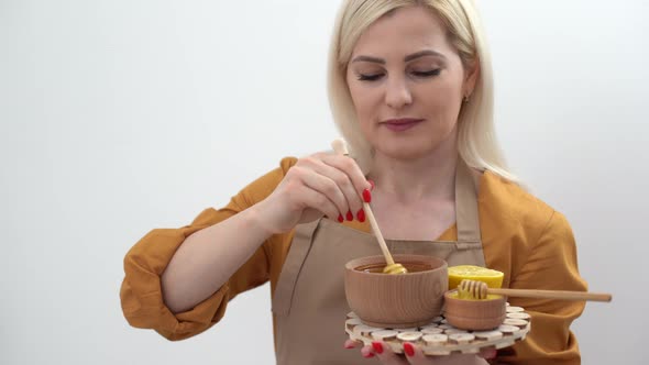 Happy Young Woman Holding Wooden Bowl of Honey Copy Space